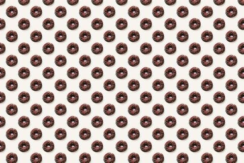 Black donuts with red glaze on white background seamless pattern top view. Fo Stock Illustration