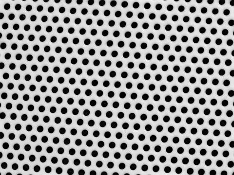 Black dots on white perforated pattern Stock Photos