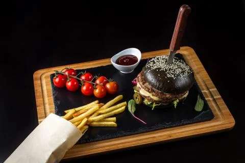 Black double hamburger made from beef with jalapeno pepper, cheese and Photos