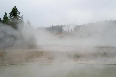 Black Dragons Cauldron Mud Volcano Area, Hazy Thermal Features and Pine For.. Stock Photos