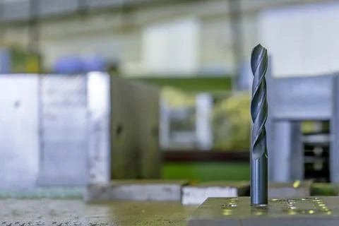 Black drill bit on the work table industria Stock Photos