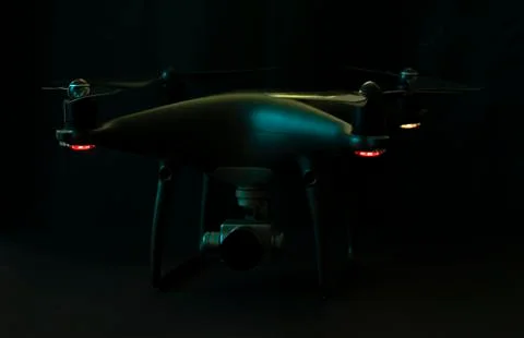 Black drone and silver camera on black background Stock Photos