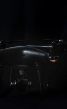 Black drone and silver camera on black background Stock Photos
