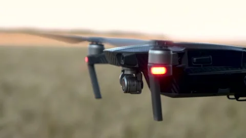A black drone flies over a wheat field. close-up drone camera on gimbal Stock Footage 157318925