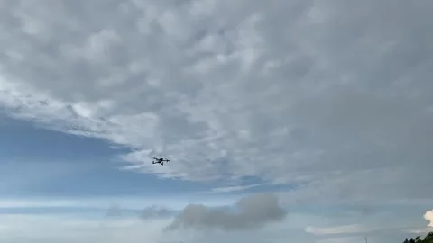 Black Drone Hovering in Cloudy Blue Sky Stock-Footage 332528066