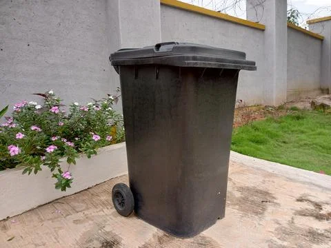 Black dustbin on a compound. Stock Photos