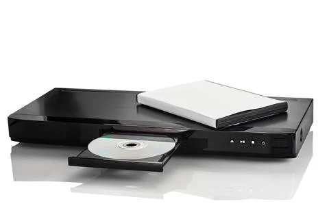 A black DVD player with a compact disc and a white case, isolated on a white  Stock Photos