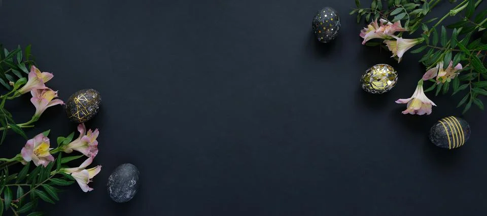 Black easter eggs with gold pattern and pink flowers Stock Photos