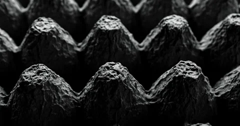 Black egg carton texture with dramatic lighting and repeating molded paper peaks Stock Footage 344971566