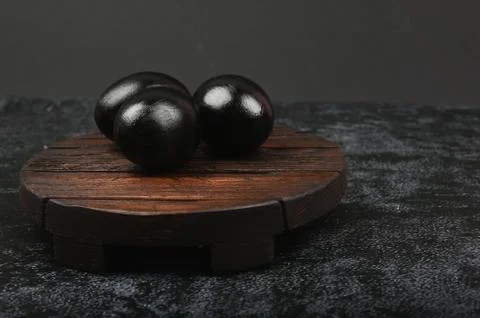 Black eggs on on a dark background. flat lay. Black Easter. three black eggs Stock Photos