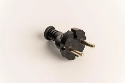 Black electric plug lying on a clean white background Stock Photos