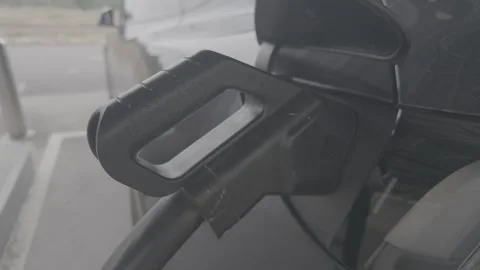 A black electric vehicle is charging. Stock Footage 344011162