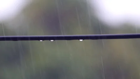 From the black electric wires fall drops of heavy rain. 4k, 3840x2160. HD Stock Footage 90842591