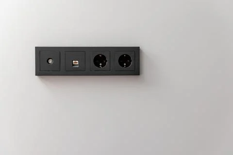 A black electrical box with four outlets Stock Photos