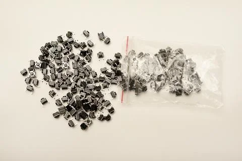 Black electronic buttons in a plastic bag. Electronic elements. 스톡 사진