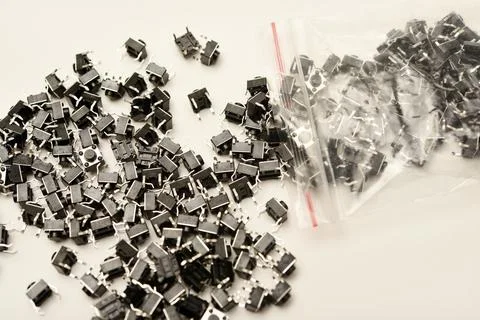 Black electronic buttons in a plastic bag. Electronic elements. 스톡 사진