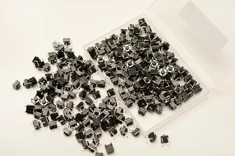 Black electronic buttons in a plastic container. Electronic elements. 스톡 사진