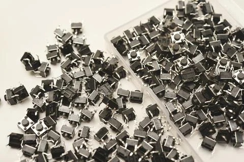 Black electronic buttons in a plastic container. Electronic elements. 스톡 사진