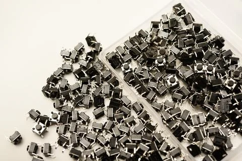 Black electronic buttons in a plastic container. Electronic elements. Stock-Fotos