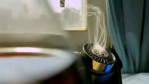Black Electronic Diffuser Emitting Smoke By Window Stock Footage 346053868