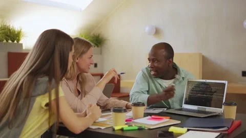 Black employee demonstrating app code to coworkers Stock Footage 142543093