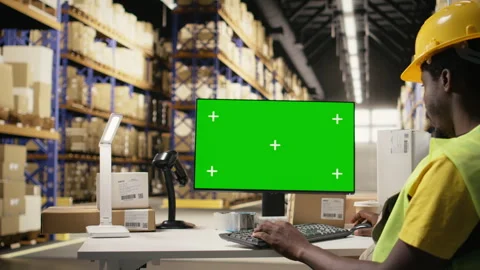 Black employee in depot setting looking at copy space screen on pc Video stock 315541387