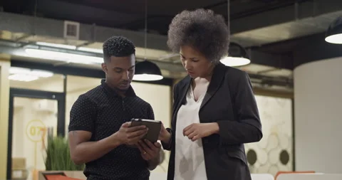 Black employees discussing data on tablet Stock Footage 195217319