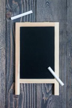 Black empty chalkboard for copy space with pieces of chalk 스톡 사진