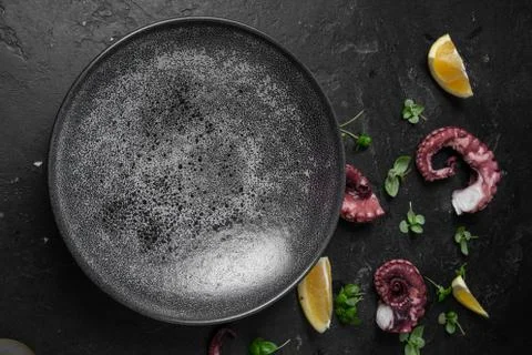 Black empty plate on marble, flatlay - stylish tableware, table decor and foo Stock Photos