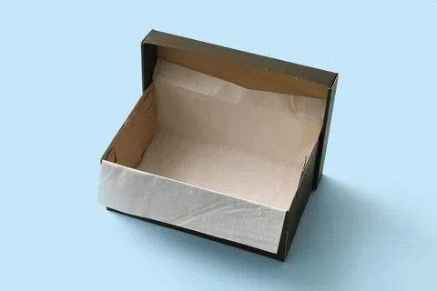 Black empty shoebox on blue background Stock Photos