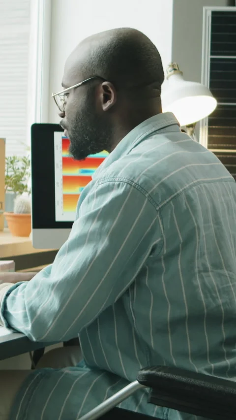 Black Engineer with Disability Developing Renewable Project in Home Office Stock Footage 328527056