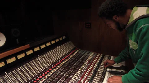 Black Engineer pushing faders and buttons Recording Studio - Ew 14 Stock Footage 34929632