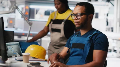 Black engineer runs diagnostic checks on solar panel assembly software Stock Footage 309152298