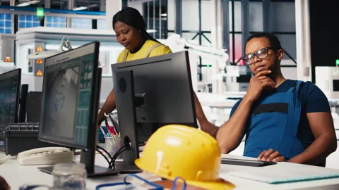 Black engineer runs diagnostic checks on solar panel assembly software Stock Footage 309155238