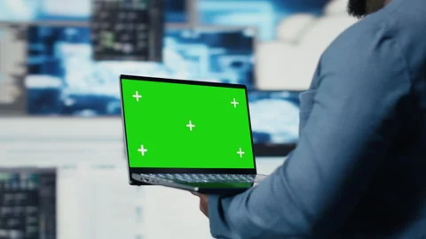 Black engineer works on binary code with chroma key on laptop Stock Footage 312359497