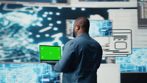 Black engineer works on binary code with chroma key on laptop Stock Footage 312413685
