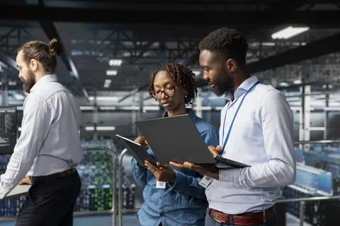 Black engineering team doing maintenance on servers used for AI processing 写真素材