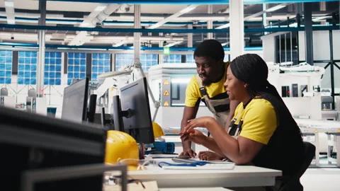 Black engineering team working at a high tech solar panel factory Stock Footage 309076904