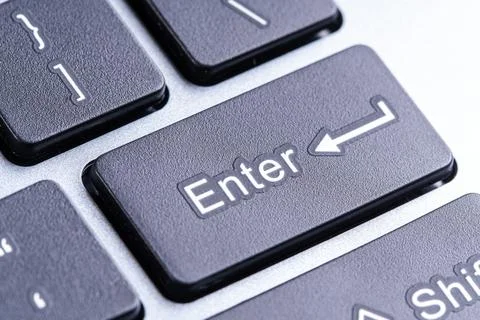 Black Enter key on a gray keyboard Fotos de archivo