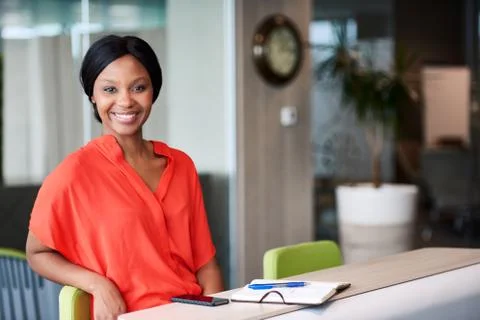 Black entrepreneur smiling at the camera while sitting at home Foto stock