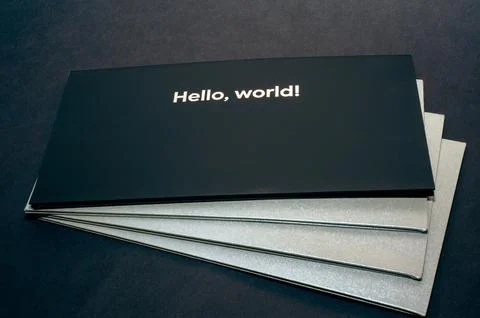 Black envelope on top, on gray envelopes on the bottom, on a dark flat backgr Stock Photos
