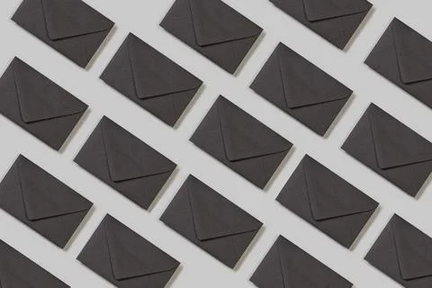 Black envelopes on a gray background in a top view Foto stock