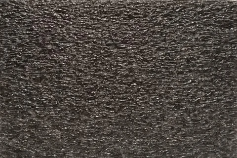 Black EPE foam polyethylene packaging as background Stock Photos