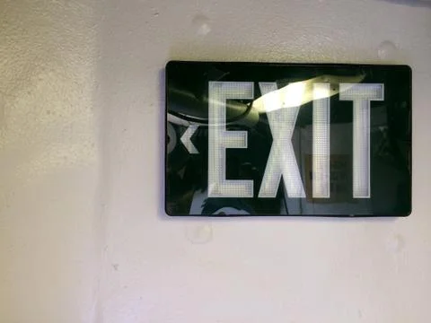 Black exit sign at emergency exit door background Stock Photos