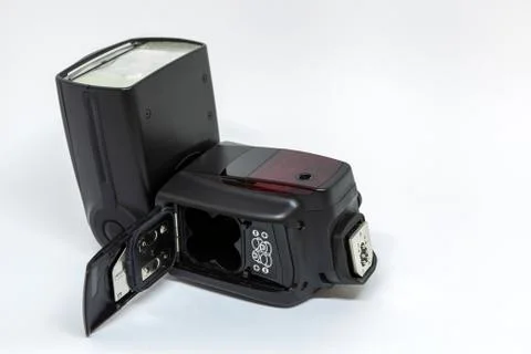 Black external flash for a camera with an open battery compartment Stock Photos
