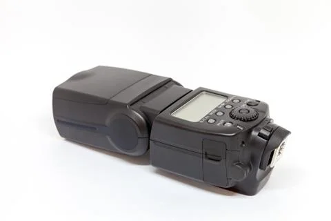 Black external flash for a camera on a white background Stock Photos