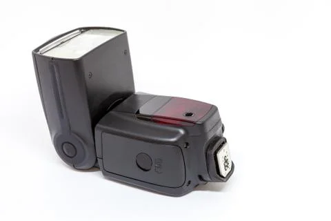 Black external flash for a camera on a white background Stock Photos
