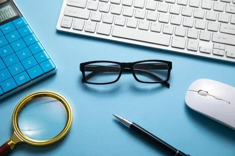 Black eyeglasses on the computer keyboard. Stock Photos