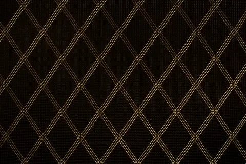 Black fabric with a gold pattern. Stock Photos