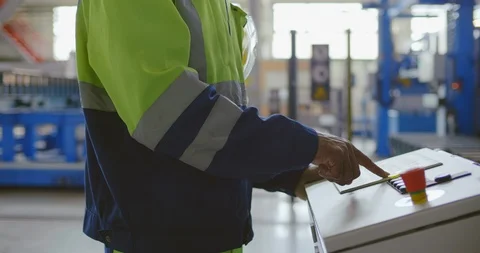 Black factory worker is programming a CNC machine with a control panel close Stock Footage 121101618